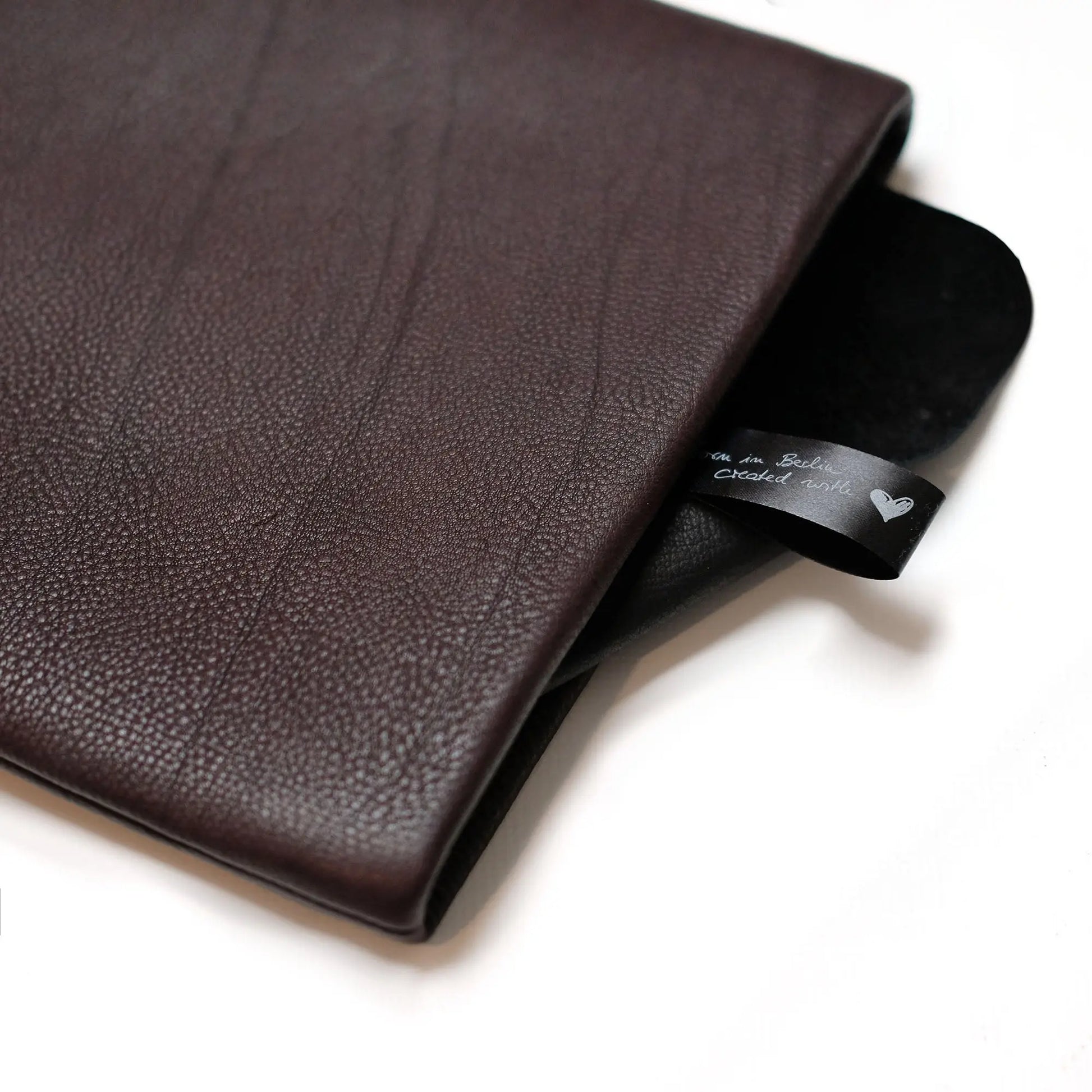 dunkelbraune Notebookhülle aus Leder mit Verschlussklappe in schwarzem Leder